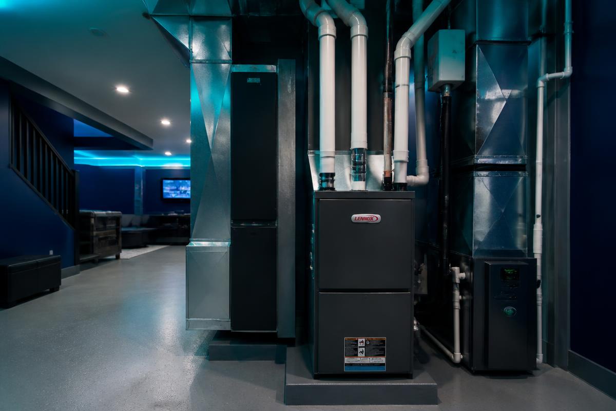 Newly installed high-efficiency furnace and sealed ductwork in a Denver basement